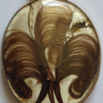 Intricate hairwork on the reverse of a miniature portrait of an aristocratic child