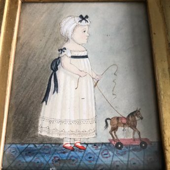 Watercolour portrait of a child with a toy horse on wheels