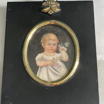 Miniature portrait of a child holding flowers