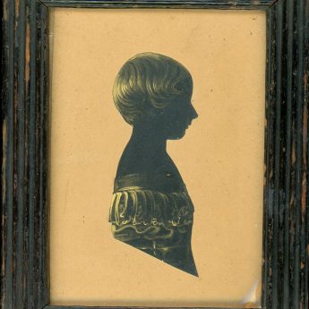 Cut and gilded silhouette of a child with an interesting trade label reverse
