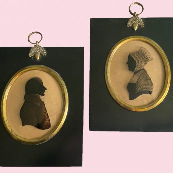 A pair of silhouettes painted on glass