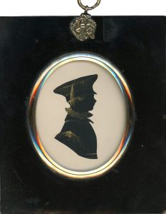 Cut and bronzed silhouette of a boy in a peaked cap