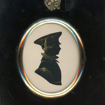 Cut and bronzed silhouette of a boy in a peaked cap