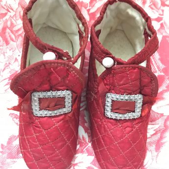 A pair of ruby red children's shoes, circa 1800