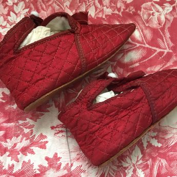 A pair of ruby red children's shoes, circa 1800