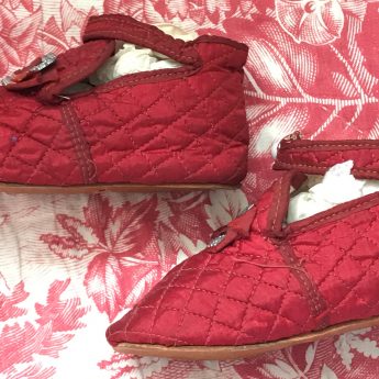 A pair of ruby red children's shoes, circa 1800