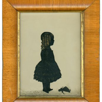 Cut and bronzed silhouette of a child with a doll