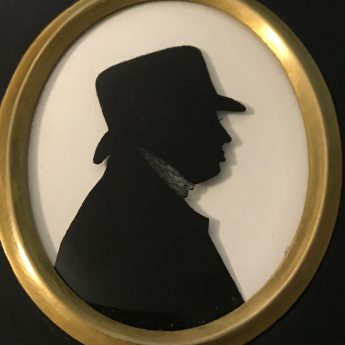 Silhouette of a gentleman in a soft-crowned hat