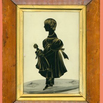 Cut and gilded silhouette of a child with a doll
