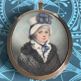 Miniature portrait of a lady in a chip hat trimmed with blue ribbon