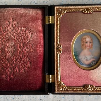 Miniature portrait of a child in a carved case