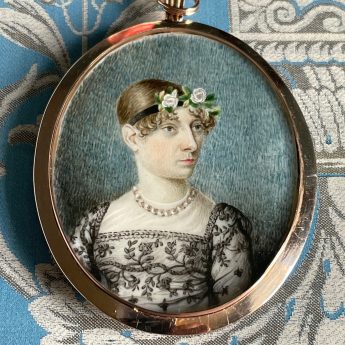Miniature portrait of a Regency lady in an embroidered grey lace dress