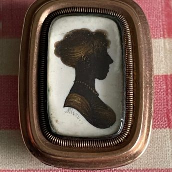 John Field, gilded silhouette of a lady in a brooch setting