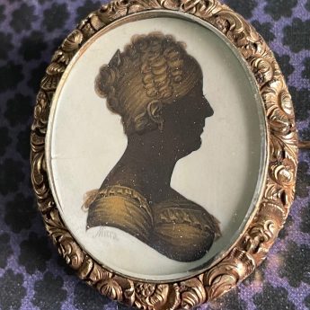 John Field, gilded silhouette of a lady in a brooch setting