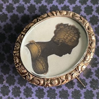 John Field, gilded silhouette of a lady in a brooch setting