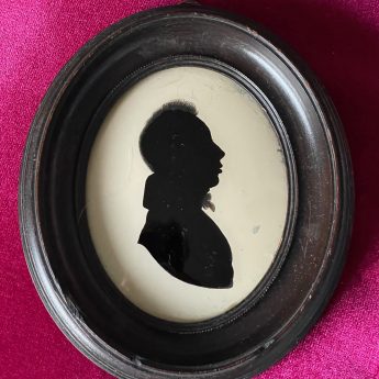 Silhouette of a gentleman reverse painted on glass by Charles Rosenberg