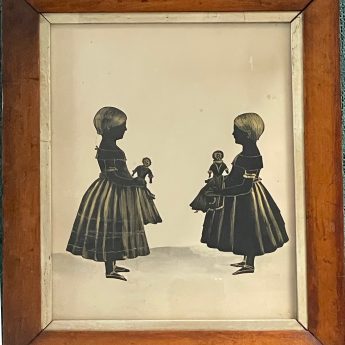Cut and gilded silhouette of two girls holding dolls