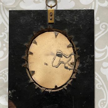 A pair of silhouettes painted on plaster with gilding