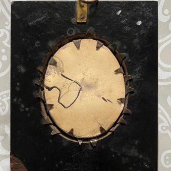 A pair of silhouettes painted on plaster with gilding