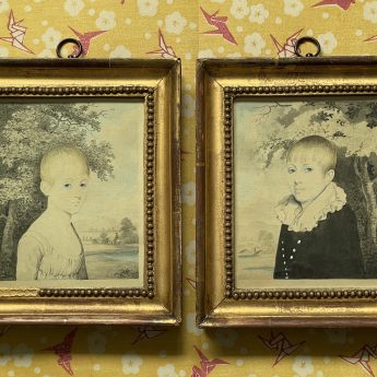 Small pair of watercolour portraits of children in a garden landscape
